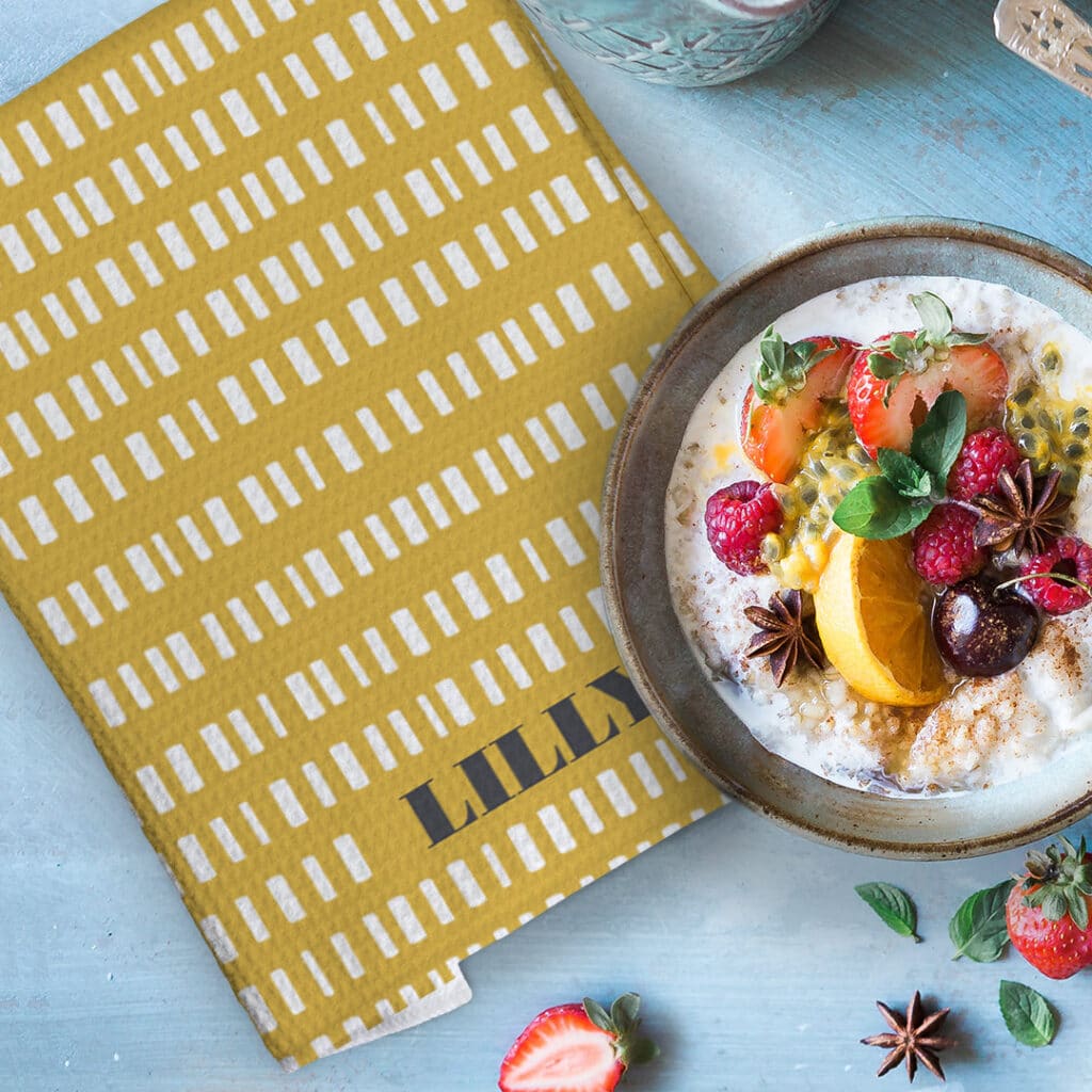 Bowl of cereal and fruit on a pineapple tea towel