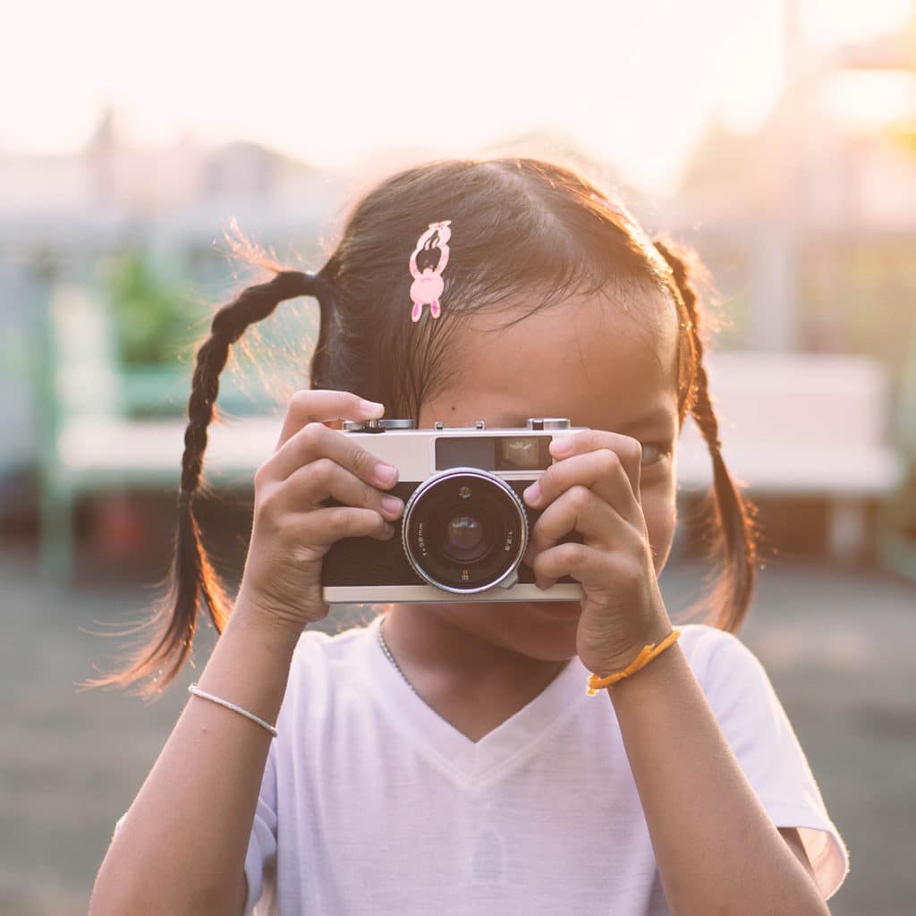 Girl taking photo with camera