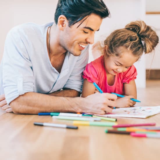 Father and daughter coloring together
