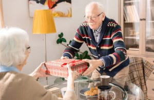 old man giving wife a gift