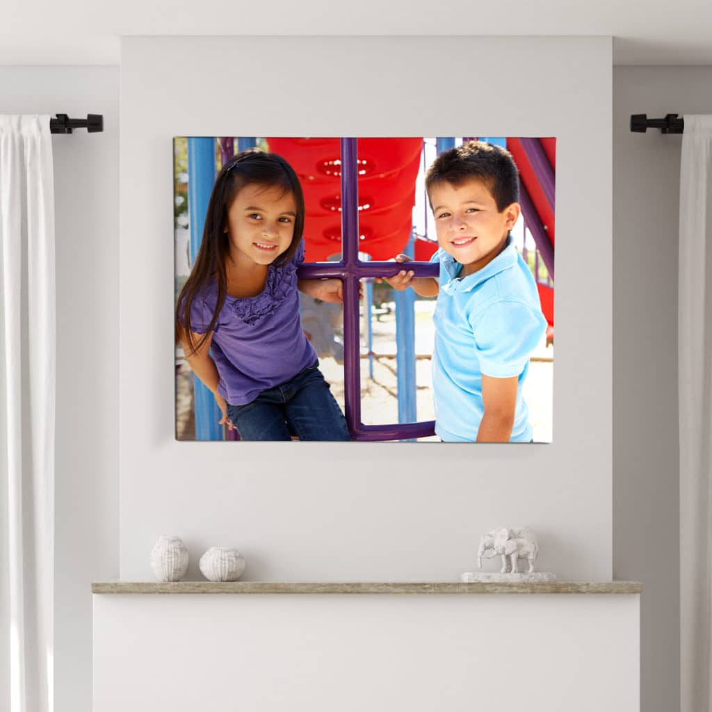 Large size canvas print with a photo of two kids hanging on the wall