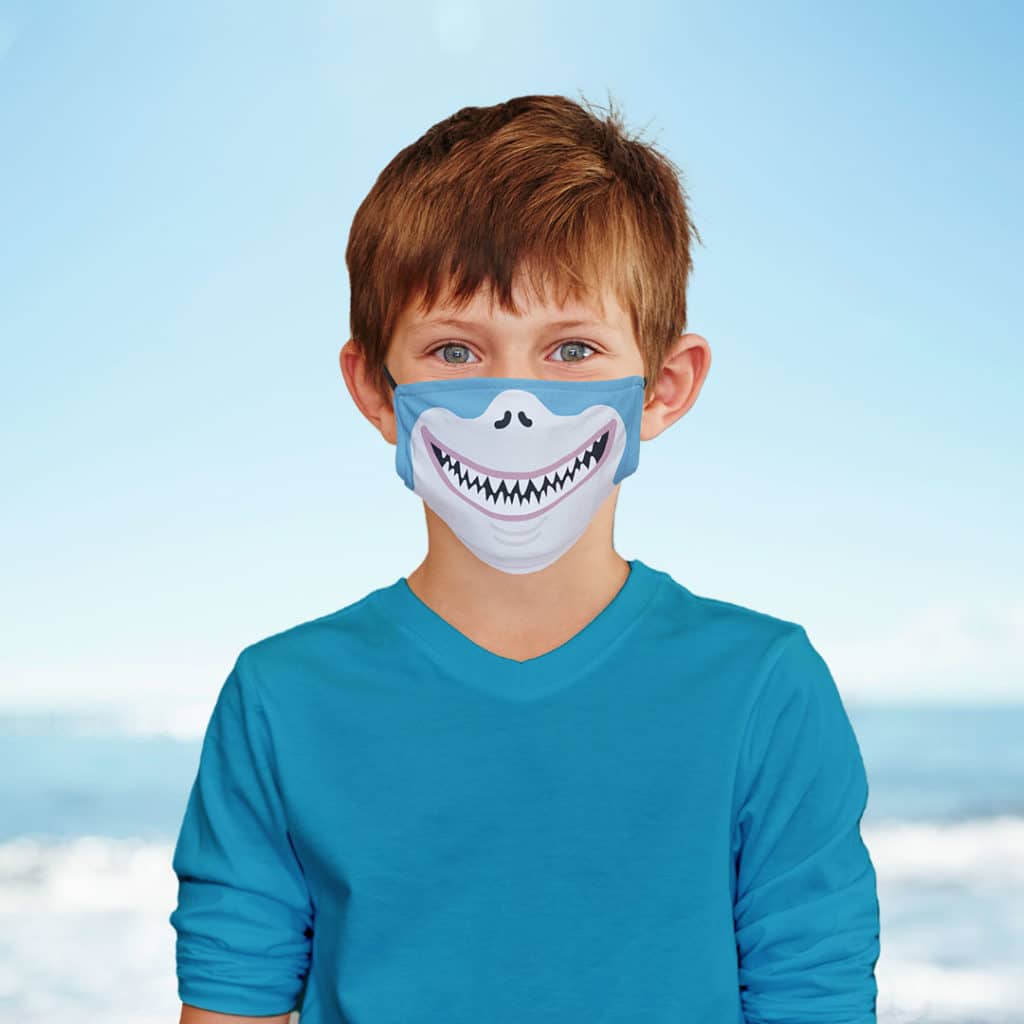 Young boy wearing shark face mask