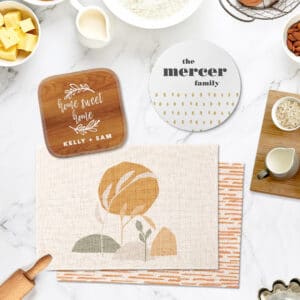 Kitchen accessories including pot holder, trivet, and placemats in bright, warm neutrals