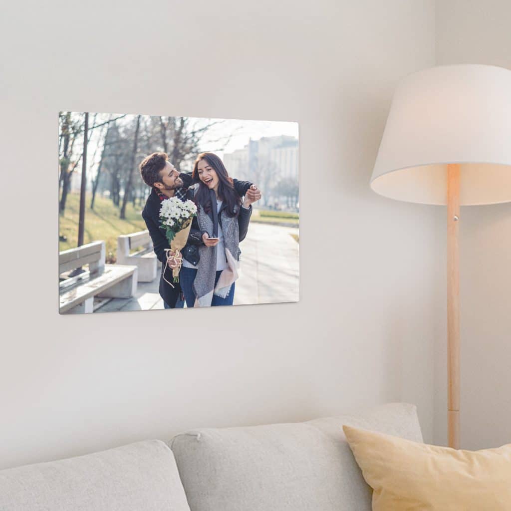 Cute couple featured on a metal photo panel hanging over a couch