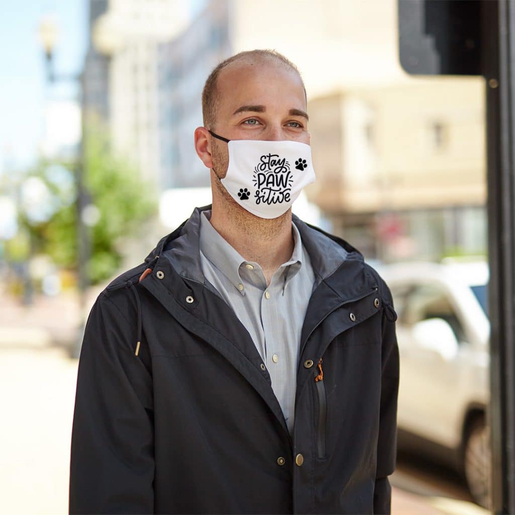 Image of man wearing a custom face mask that reads "Stay Pawsitive"