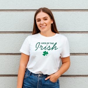 Girl smiling while wearing a white Luck Of The Irish t-shirt