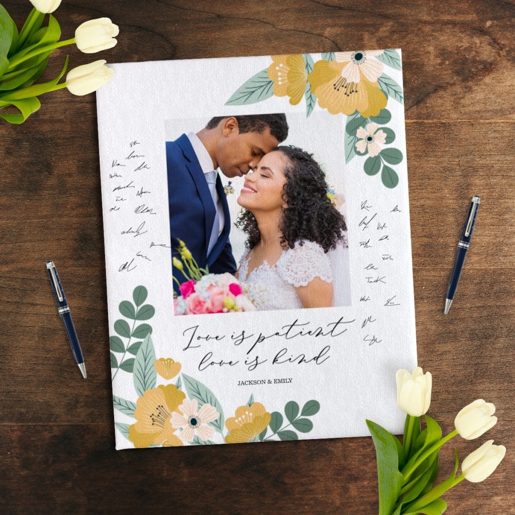 Photo canvas being used as a wedding guest book, covered in signatures