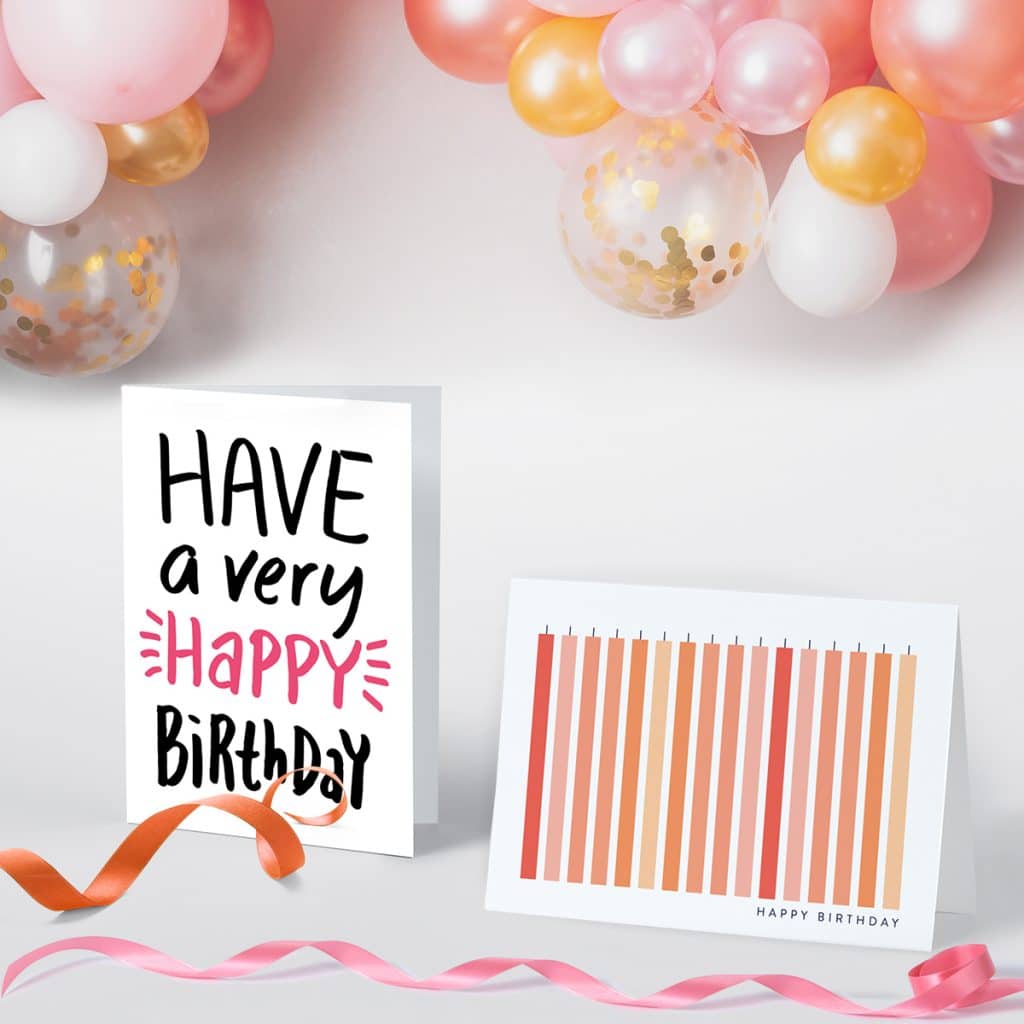 Pink birthday greeting cards standing up surrounded by bright pink ribbon