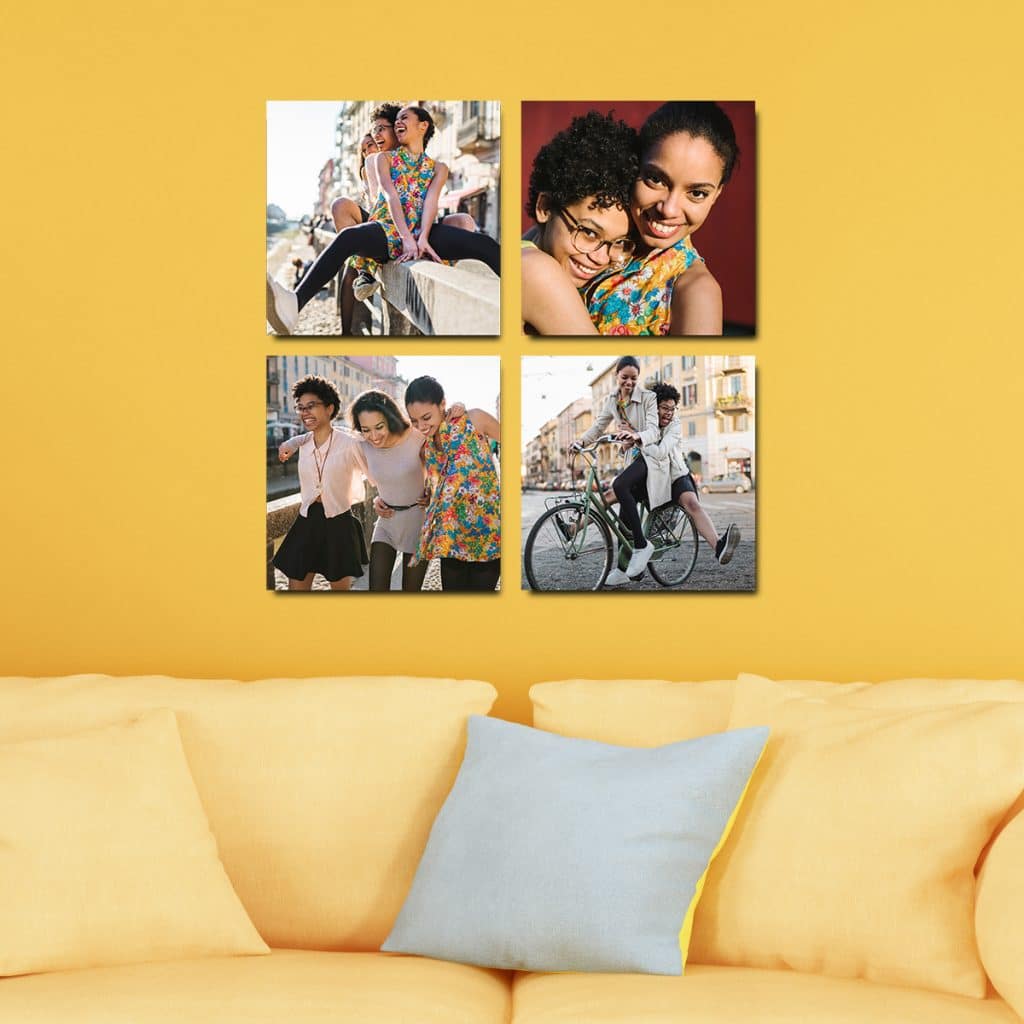 Four 8x8 photo tiles hanging on a yellow wall above a yellow couch