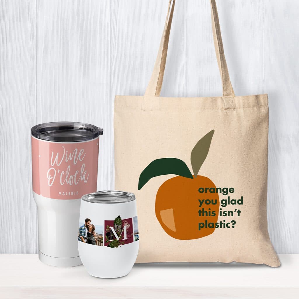 Insulated drinkware and a custom canvas tote bag leaning against a wall