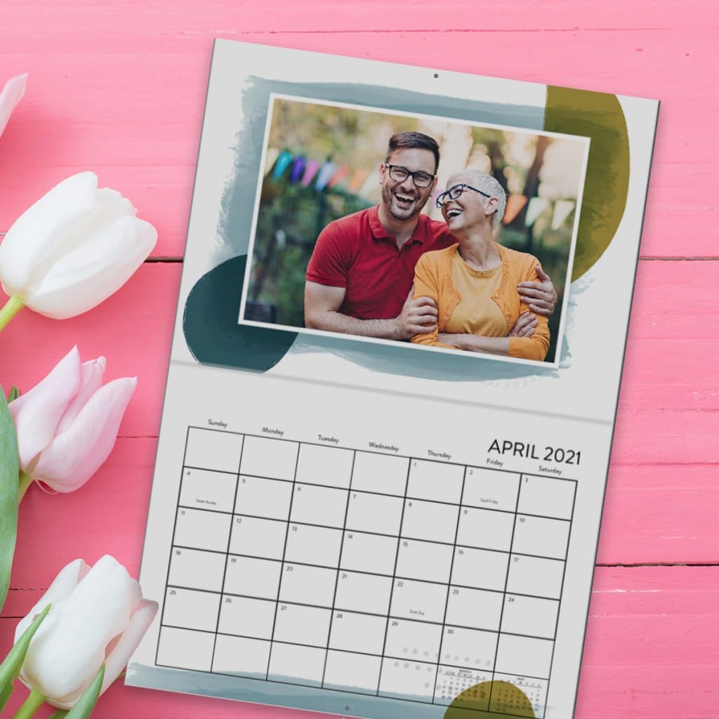 Wall calendar showing April 2021 featuring a photo of a mother and her adult son