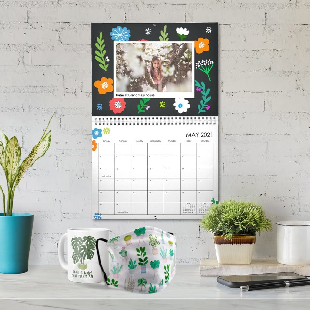 Plant-inspired designs on a mug, face mask, and hanging wall calendar