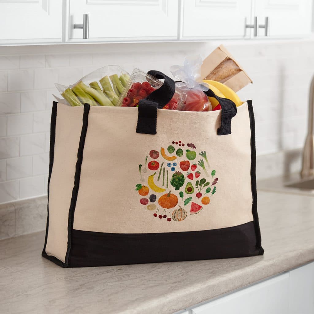 Large premium cotton tote sitting on a counter full of groceries