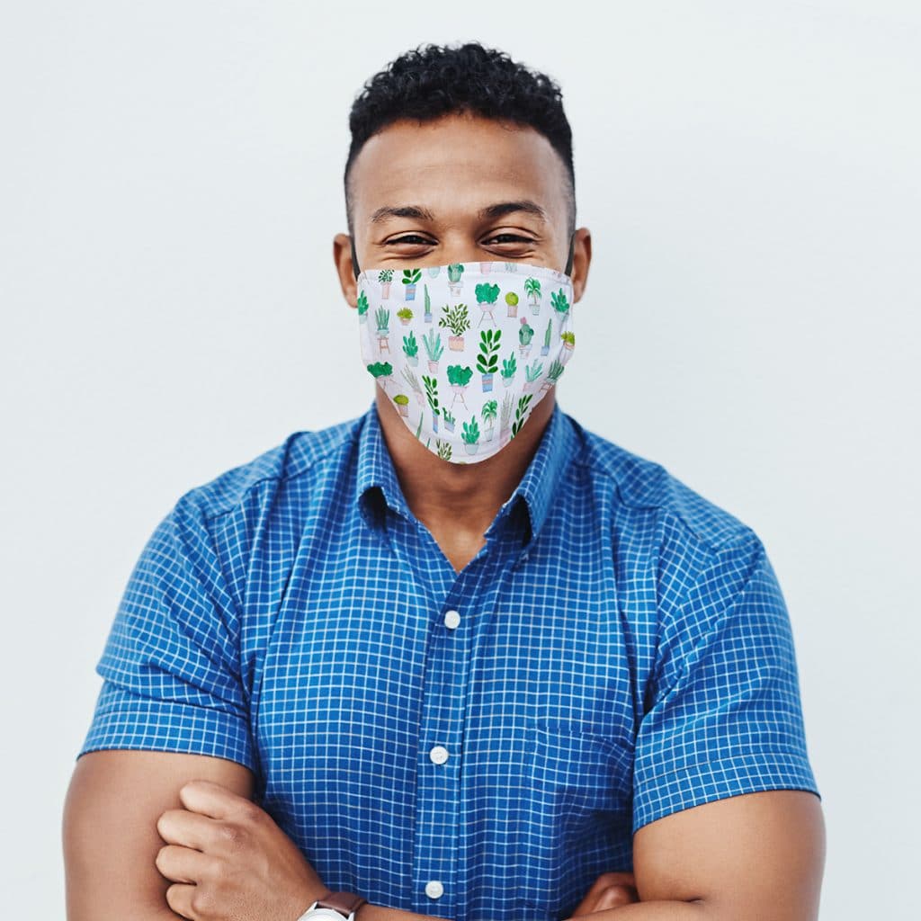 Man wearing a custom face mask with house plant pattern design