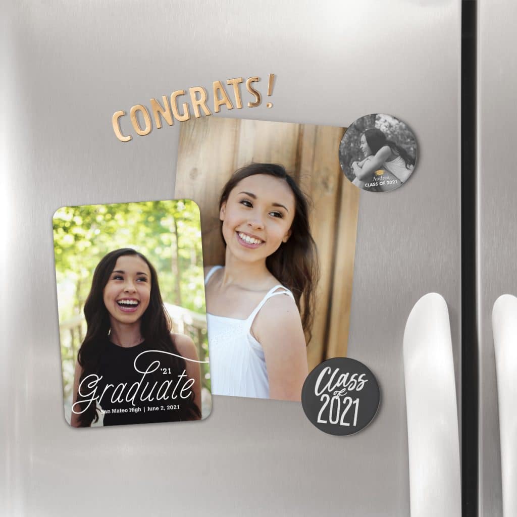 Round refrigerator magnets holding up 2021 graduation announcements