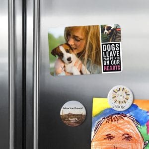 Fridge covered in round photo magnets and square magnets featuring photos