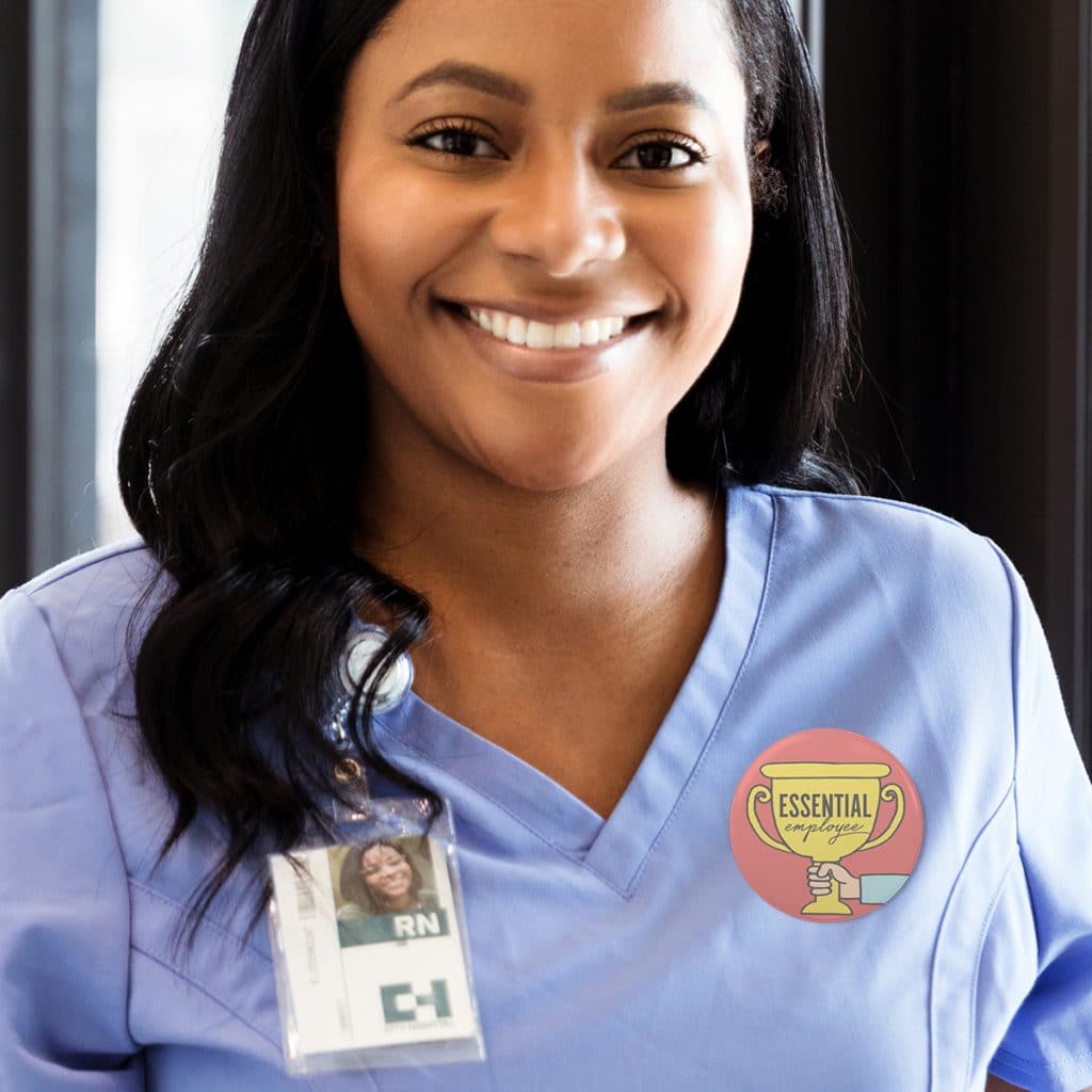 Photo of a nurse wearing an "Essential Employee" button pin