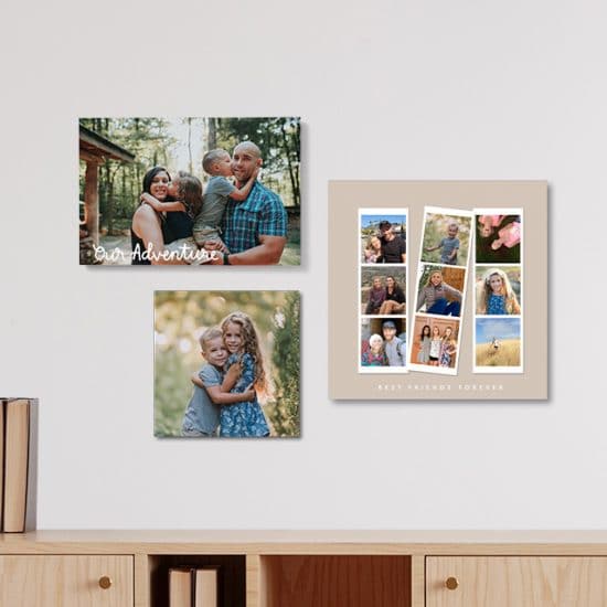 Three photo tiles in three different sizes hanging on a wall over a credenza