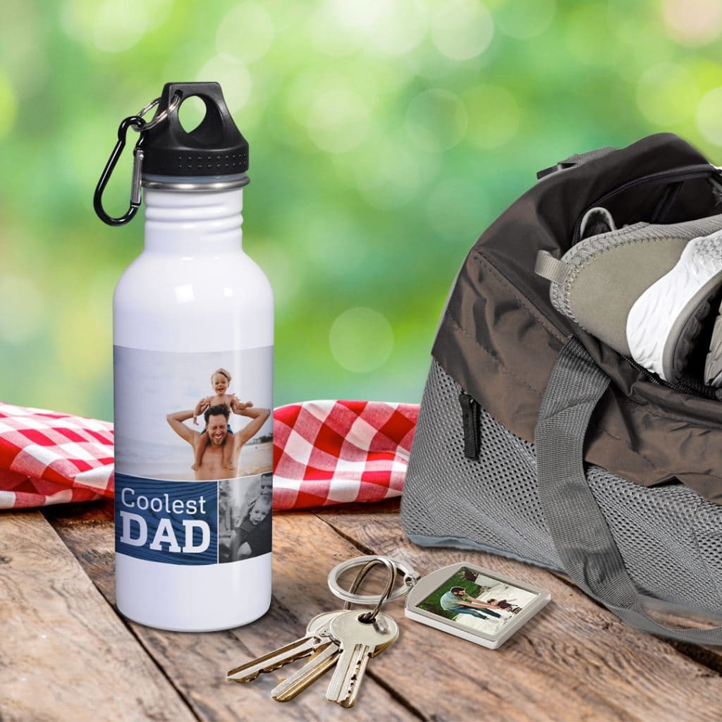"Coolest Dad" water bottle sitting next to a photo keychain featuring a photo of dad and his child