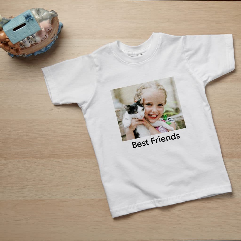 Image of a white todder tee with the words "Best Friends" and a photograph of a little girl holding a kitten.