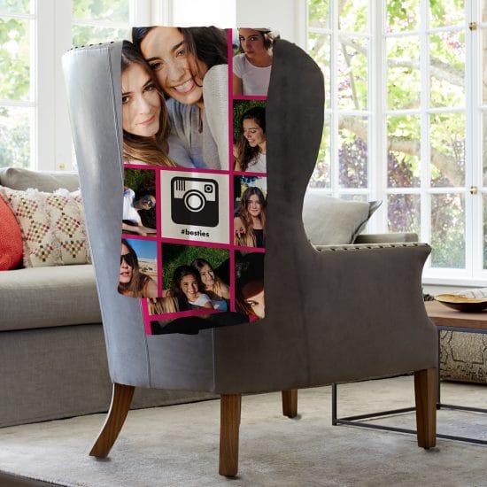 Image showing custom blanket slung over the back of a chair. Blanket shows several images of two young women smiling together.