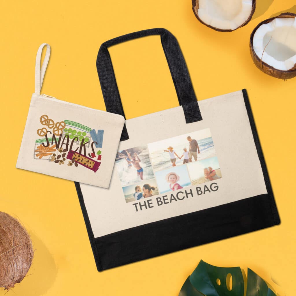 Flat lay image of a large canvas tote bag featuring "The Beach Bag" and beach images and a zippered pouch with a "Snacks" design.