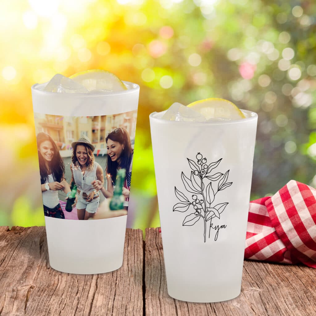 Image of two frosted pint glasses. One featuring a full photo and one with a floral design and the name Kyra