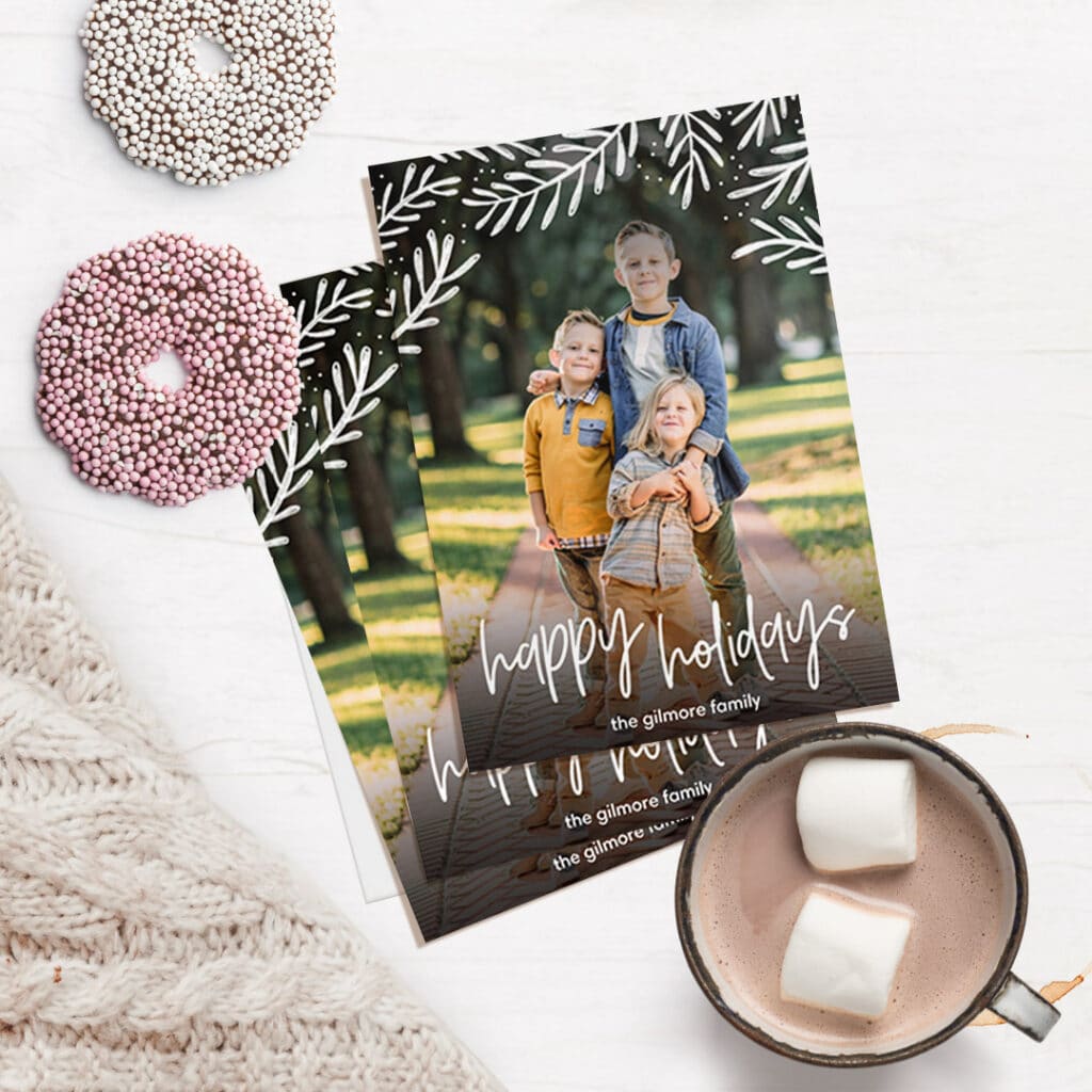 holiday photo card with surrounding cookies and hot cocoa