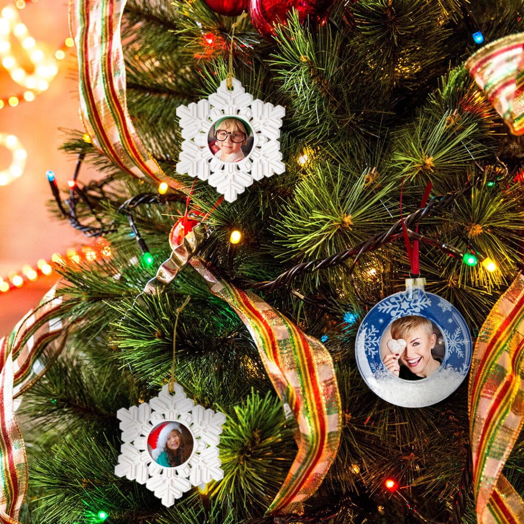 Snowflake Christmas Ornament and Snow Scene Christmas Ornament on a traditionally decorated Christmas tree