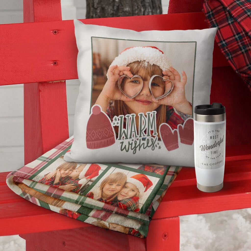 a personalized blanket and a pillow on an outdoor red bench