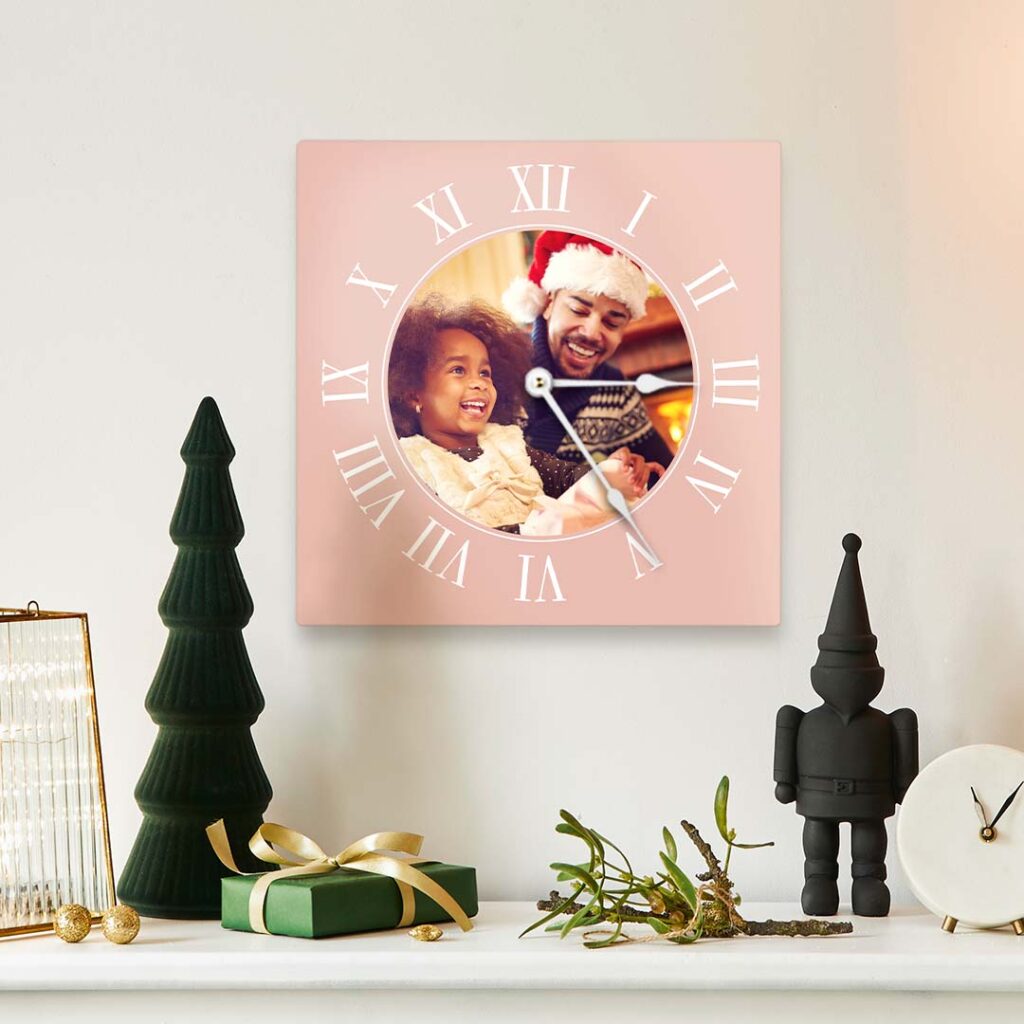 square photo clock sits above holiday mantel