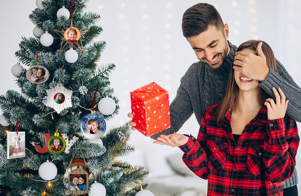 Smiling couple standing in front of a beautiful Christmas tree