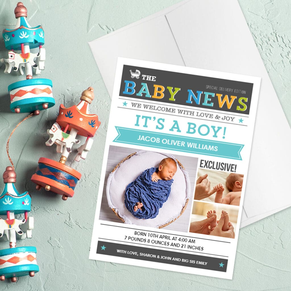 It's a boy, custom birth announcement card and envelope placed next to baby toys