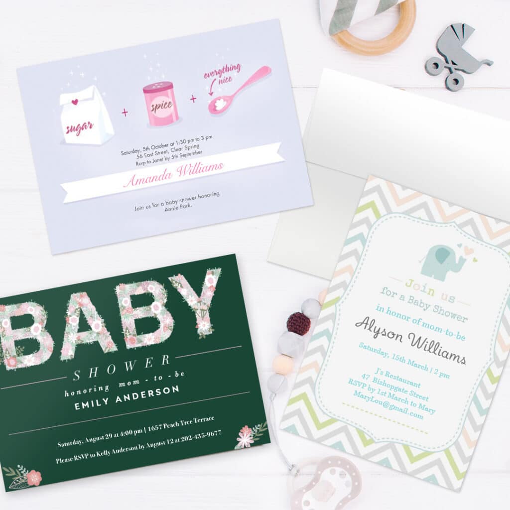 3 personalized baby shower invitation cards displayed on a surface with baby toys