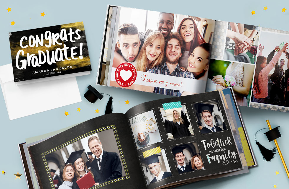 A congrats graduate black greeting card and two photo books with family images of graduates, presented on a blue surface with small graduate hats and straws